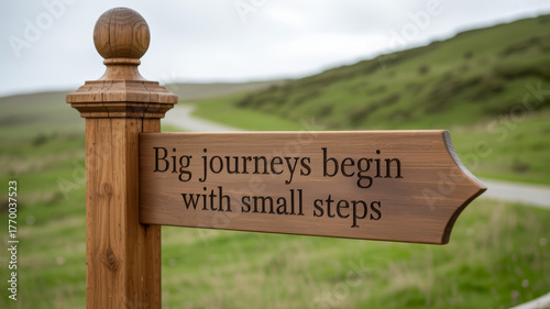 Big journeys begin with small steps directional signpost
