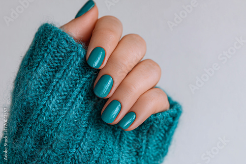 close-up of a woman's hand with a turquoise manicure
