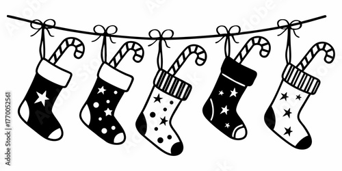 Five christmas stockings hanging on a line with candy canes and star and dot patterns in black and white
