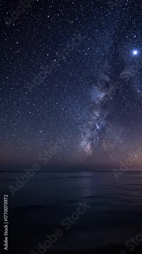 Night sky and milky way galaxy over calm ocean stellar abstract