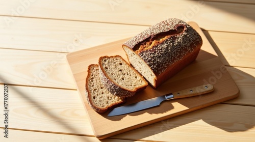 Freshly baked whole grain bread sliced on a wooden cutting board