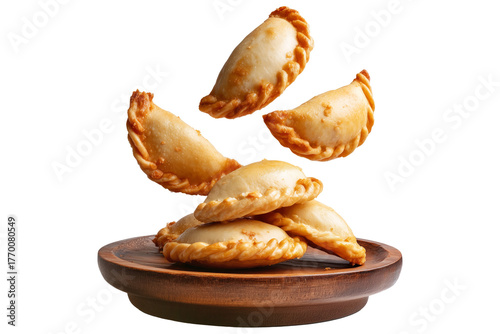 Argentina and Uruguay empanadas stacked in a pyramid, golden baked crust, meat and potato filling on wooden plate, isolated on white transparent background, concept of traditional South American Cuisi
