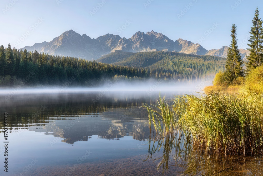 Fototapeta premium Majestic mountain lake with serene misty reflections
