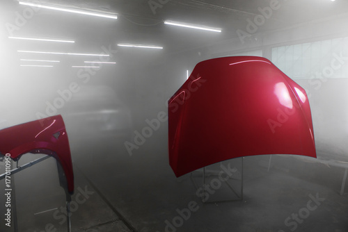 Painted parts of automobile body in auto service. Restoration painting of car in the paint chamber service.