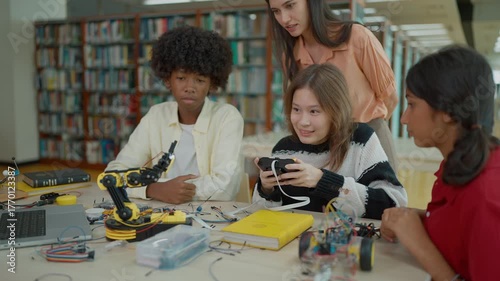 Group of students learning together to build electronic car model construction project. Innovative technology development