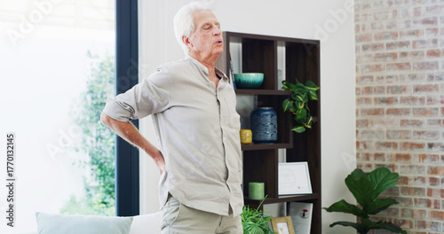 Fotografie Back pain, fatigue and retirement with old man in living room of home for condition or discomfort