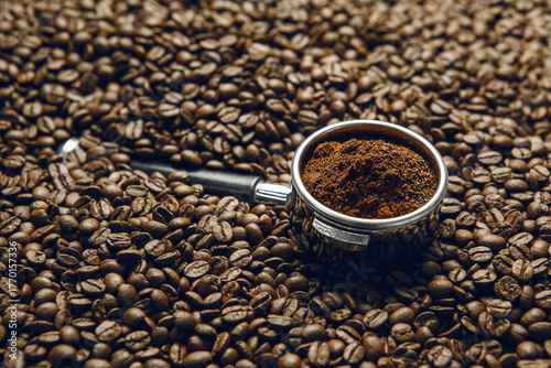 Freshly Ground Coffee in Portafilter on Roasted Coffee Beans Close Up