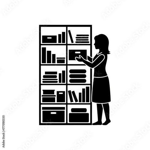 Silhouette of a woman organizing a bookshelf with books and boxes.