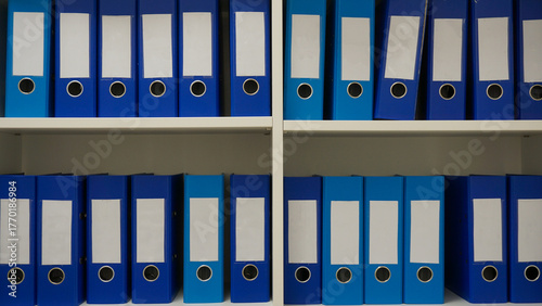 Registry or archive in blue file binders with blank spines. File document system for patient medical records or cards or any kind of documentation. Copy space