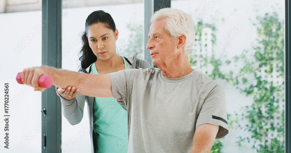 Obraz premium Physiotherapy, weights and woman with old man for mobility, rehabilitation and physical therapy. Healthcare, chiropractor and patient with dumbbells for stretching, muscle recovery and strength