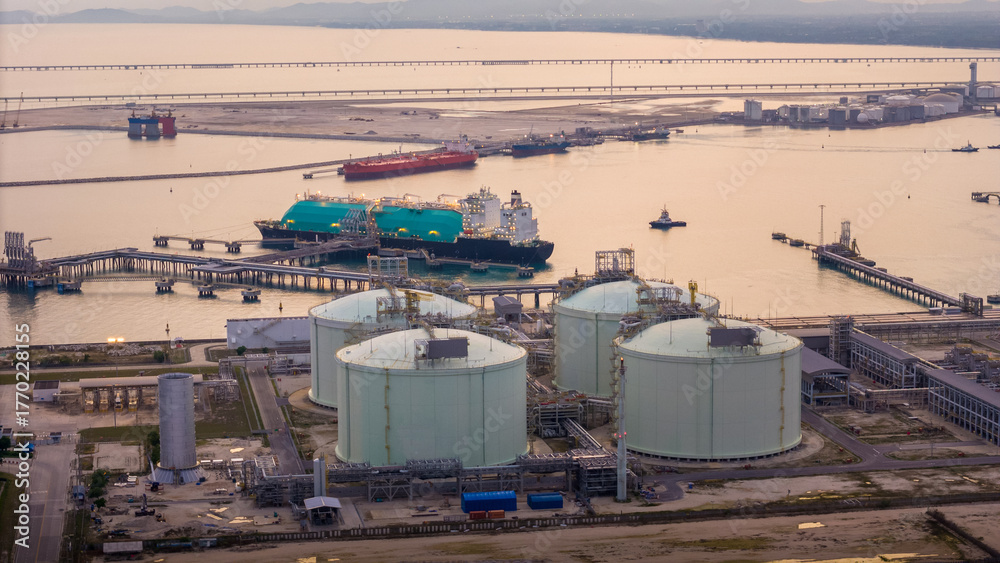 Fototapeta premium LNG (Liquified Natural Gas) tanker anchored in Gas terminal gas tanks for storage. Oil Crude Gas Tanker Ship. LPG at Tanker Bay Petroleum Chemical or Methane freighter export import transportation