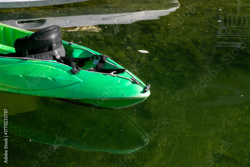 Photography A vivid green kayak drifts atop the mirror-like lagoon, whispering tales of sere