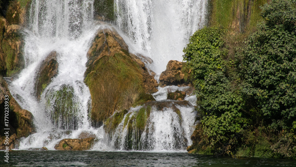 Fototapeta premium Cascading whispers of verdant waterfall evoke Earth's lush heartbeat, celebrating World Water Day and International Forest Bathing Day