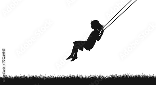Silhouette of a young girl swinging high on a swing against a white sky.