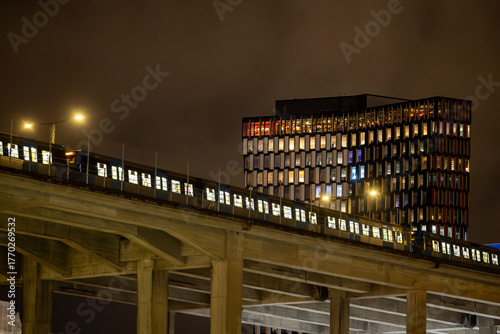 Photography Stockholm, Sweden A Tunnelbana or Metro train passes on the Skanstull bridge with the STHLM01 building in the background