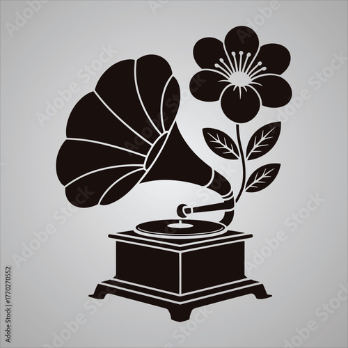 Black silhouette of an antique gramophone with a blooming flower and leaves on a gray gradient background