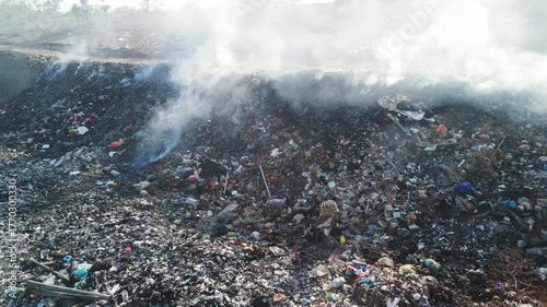 Burning trash in dump, industry drone shot in Bali, ecology concept