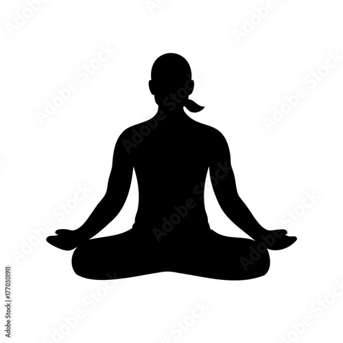 Silhouette of a woman practicing yoga in a lotus position meditation pose
