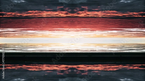 Abstract mirrored composition of a sunset or sunrise over a dark foreground.