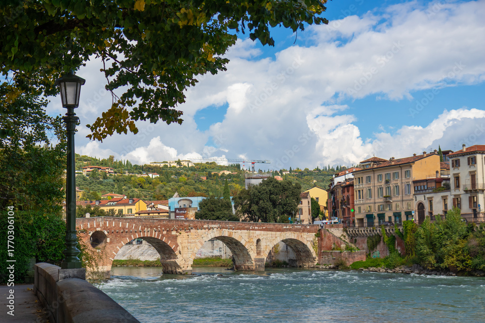 Naklejka premium The Ponte Pietra in Verona, Italy, an ancient Roman stone arch bridge spanning the Adige River in the Veneto region, a timeless symbol of classical architecture and historic heritage