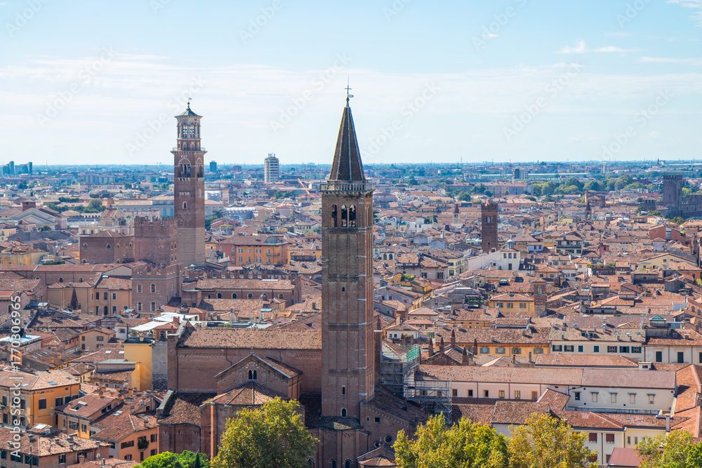 Obraz premium Aerial panoramic view of Torre dei Lamberti in Piazza delle Erbe, Verona, Italy - an iconic medieval bell tower, surrounded by red-tiled roofs and the historic heart of the Veneto region