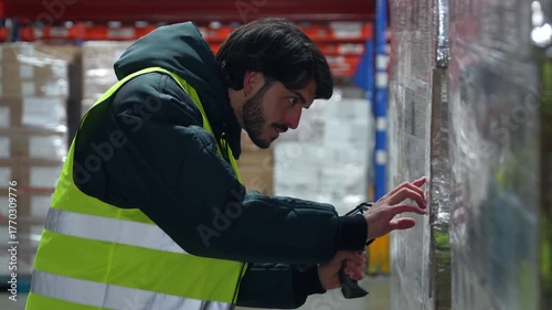 Warehouse worker scanning pallet in cold storage logistics center
