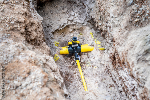 A valve and line Pipe Gas-Stop connector located on an underground pipeline. This type of yellow equipment is typically used at control points on natural gas, water, or other pressurized lines. 