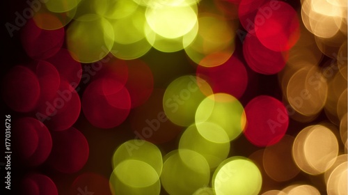 Festive red and green bokeh lights creating a warm, blurred holiday glow.