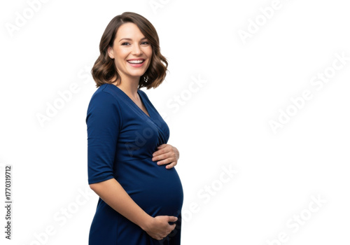 Young brunette pregnant woman, wearing a dark blue dress, smiling and holding the belly