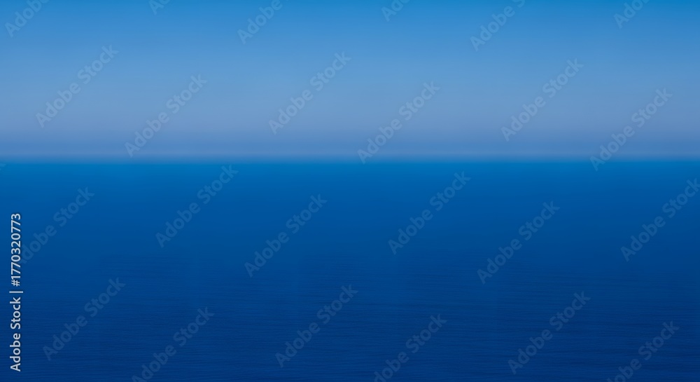 Obraz premium A serene view of the deep blue sea meeting the lighter blue sky on the horizon, creating a calming and peaceful seascape