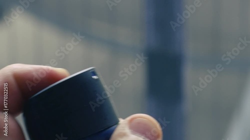 Spraying colorful paint from a can in an urban environment during daylight for artistic expression