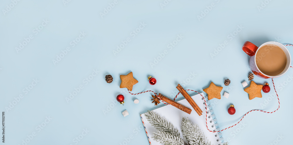 Christmas composition with holiday objects on a blue isolated background. Winter, new year concept. Flat lay, top view, copy space.