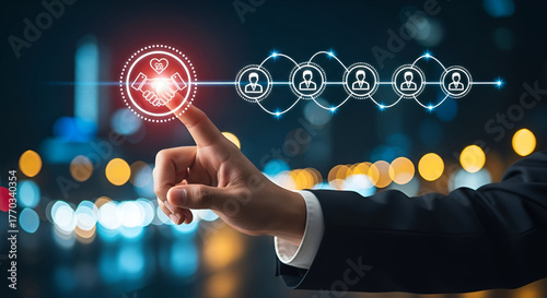 Hand Touching Network of People and Handshake Icon on Blurred City Background