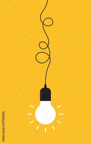 Hanging light bulb on yellow background