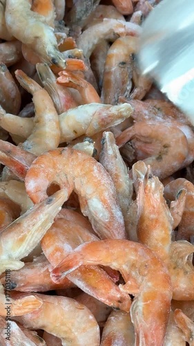 Frozen shrimp piled together for seafood background or cooking preparation themed image