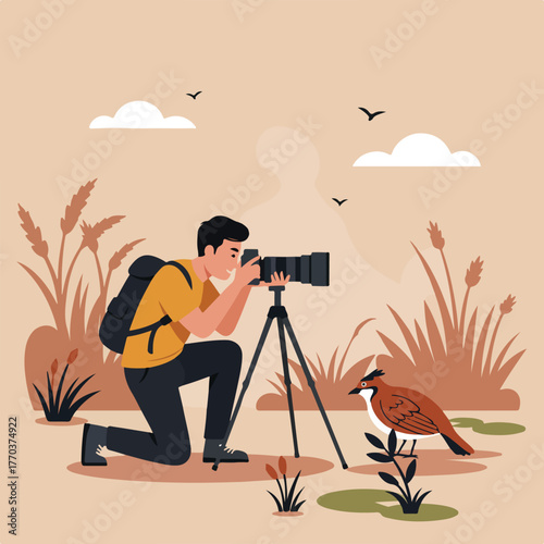 A photographer kneels in the field, using a tripod with a camera to take a photo of a bird