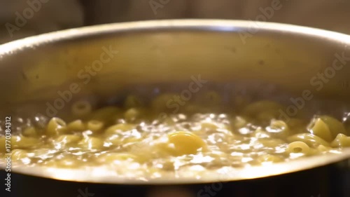 Cooking pasta in boiling water in a kitchen pot for a comfort food recipe