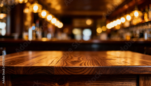 Polished wooden table in cozy ambient bar interior with glowing warm lights and blurred background of shelves and seating