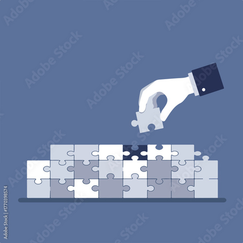 A hand places the final puzzle piece to complete a wall of puzzle pieces, symbolizing problem-solving