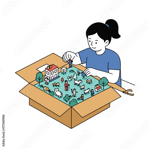 A person arranges miniature figurines in a diorama inside a box, creating a small town scene