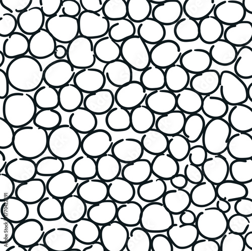 Cartoonish circles create a dense texture that mimics a stone wall, bubbles, or pavement.