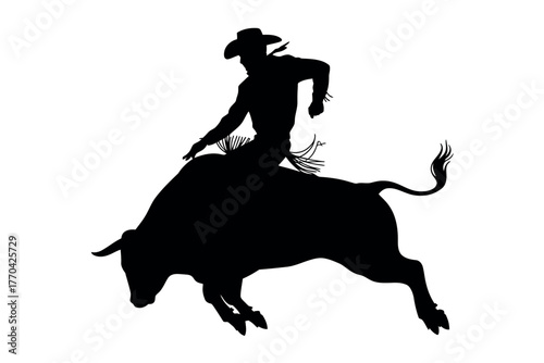 Silhouette of a cowboy riding a bucking bull in a rodeo event.