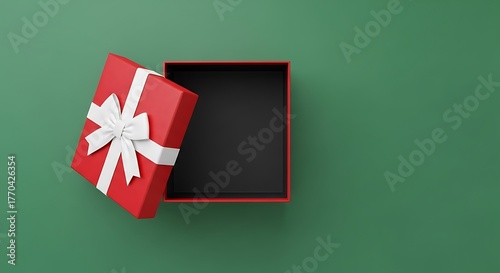 Open red gift box with white ribbon on a green background perfect for holiday promotions and special occasion marketing campaigns and seasonal greetings