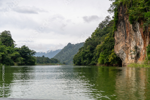 A river with a green color and a mountain in the background