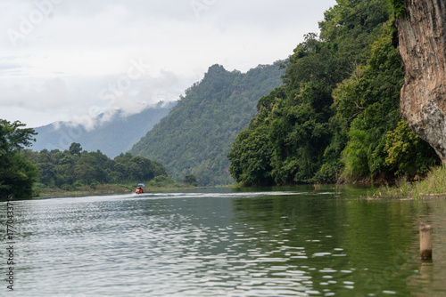 A man is in a boat on a river