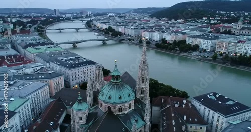 Aerial view of Vienna, Austria, featuring the Votivkirche and the Danube River.