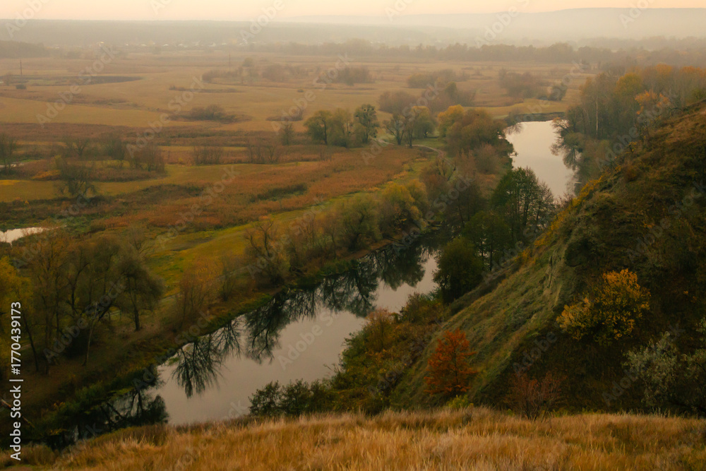 Fototapeta premium Peaceful autumn river valley seen from a high viewpoint