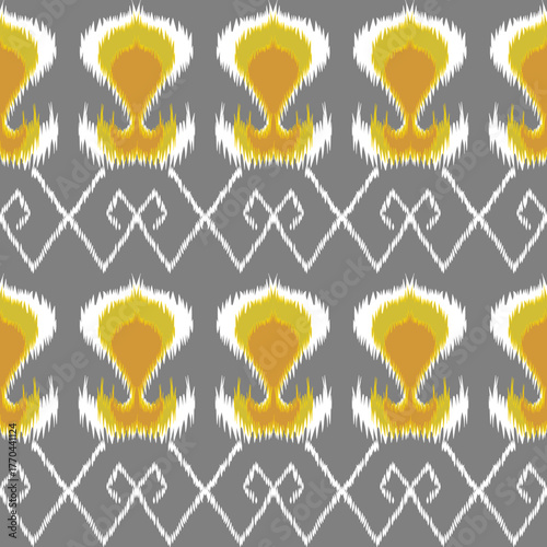Geometric ikat pattern with diamond motifs in green and white on a warm yellow background, creating a bold and traditional textile design.