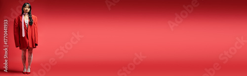 Canvas Print Chic winter fashion with a stylish young Asian woman in vibrant red and white at