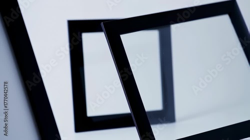 Black picture frames against a light background